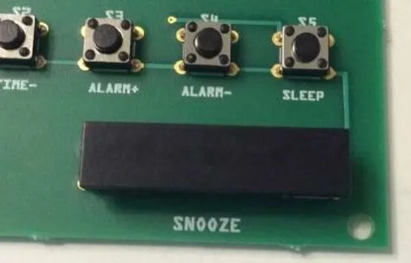 Use super glue to stick a 7.5 mm x 31 mm (0.3 in x 1.2 in) piece of black, rigid plastic to S6 and S7, forming the snooze bar.